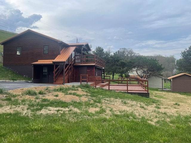 3747 Mountain Rd, Cedar Bluff, VA 24609 - view of side of home with a deck, stairway, a yard, and metal roof