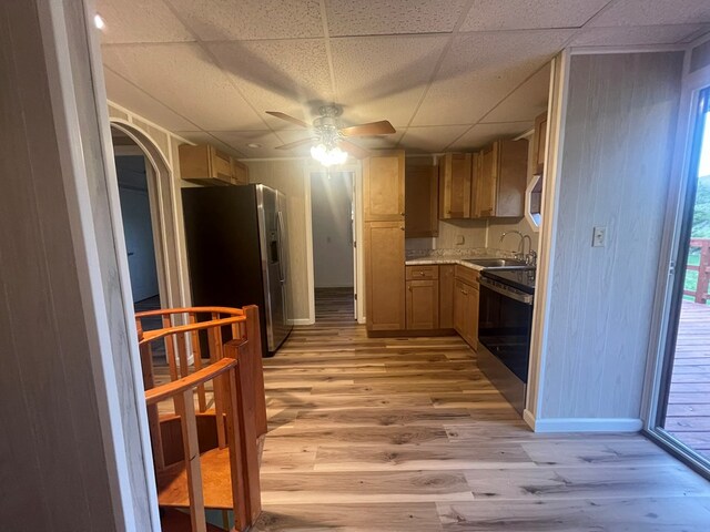 3747 Mountain Rd, Cedar Bluff, VA 24609 - kitchen with stainless steel fridge, a sink, a drop ceiling, a ceiling fan, and light wood-style flooring