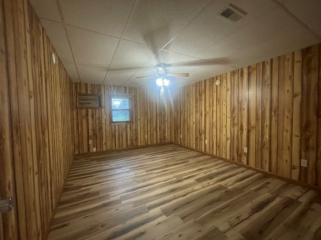 3747 Mountain Rd, Cedar Bluff, VA 24609 - empty room with wood finished floors, a paneled ceiling, wooden walls, and ceiling fan