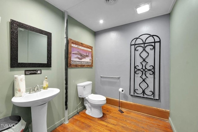 24 6th St, Bristol, TN 37620 - half bathroom with visible vents, baseboards, wood finished floors, and toilet