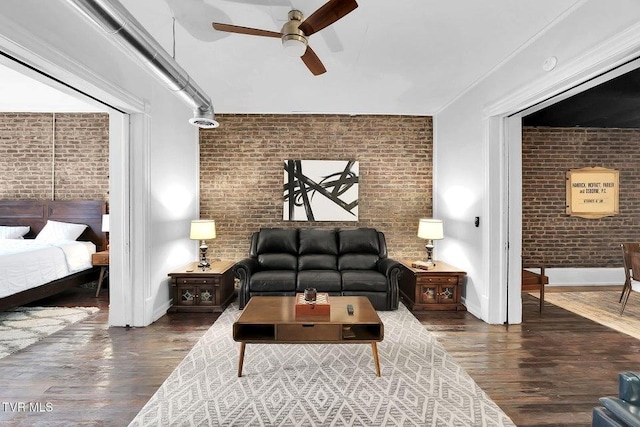 24 6th St, Bristol, TN 37620 - living room featuring ceiling fan, wood finished floors, baseboards, and brick wall