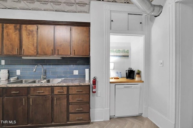 24 6th St, Bristol, TN 37620 - kitchen featuring white dishwasher, a sink, light countertops, backsplash, and baseboards