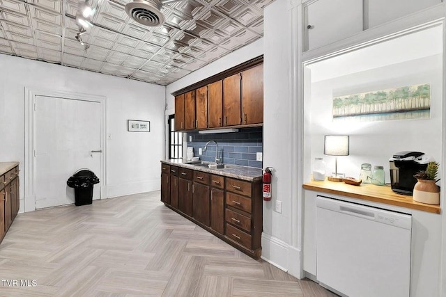 24 6th St, Bristol, TN 37620 - kitchen with light countertops, dishwasher, baseboards, and a sink