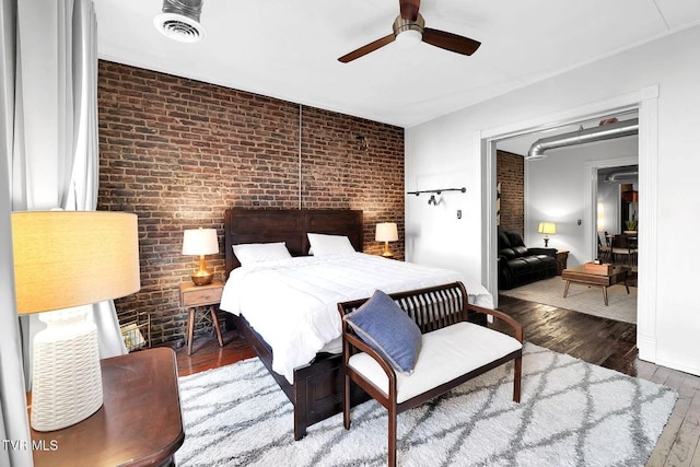 24 6th St, Bristol, TN 37620 - bedroom with brick wall, a ceiling fan, wood finished floors, and visible vents