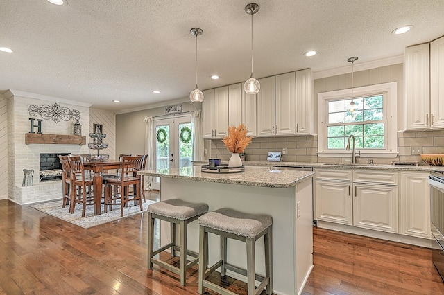420 Brookwood Dr, Bristol, TN 37620 - kitchen with a textured ceiling, french doors, decorative backsplash, crown molding, and dark wood-style flooring
