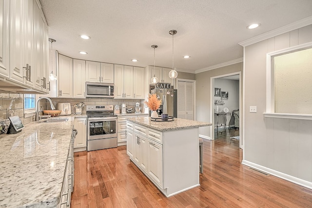 420 Brookwood Dr, Bristol, TN 37620 - kitchen featuring appliances with stainless steel finishes, tasteful backsplash, ornamental molding, light wood-type flooring, and recessed lighting