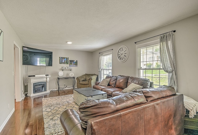 420 Brookwood Dr, Bristol, TN 37620 - living area featuring a textured ceiling, a glass covered fireplace, and wood finished floors