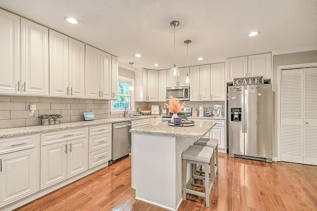 420 Brookwood Dr, Bristol, TN 37620 - kitchen with stainless steel appliances, ornamental molding, white cabinets, light wood-style floors, and recessed lighting