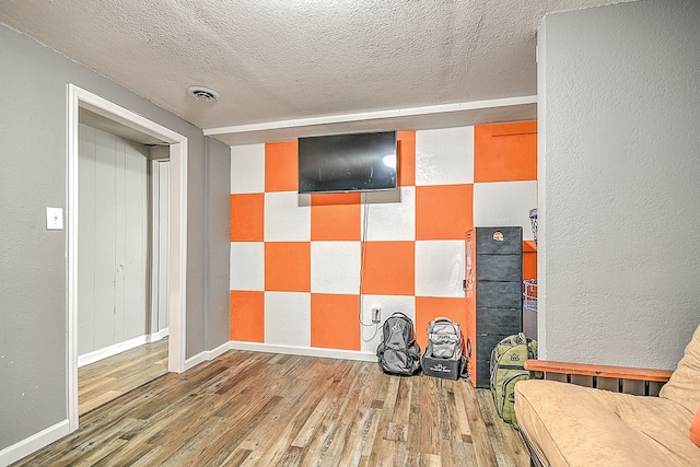 420 Brookwood Dr, Bristol, TN 37620 - sitting room featuring wood finished floors, a textured ceiling, and a textured wall