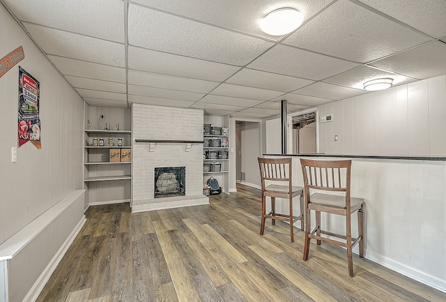 420 Brookwood Dr, Bristol, TN 37620 - living area featuring wood finished floors, a drop ceiling, a bar, and a fireplace