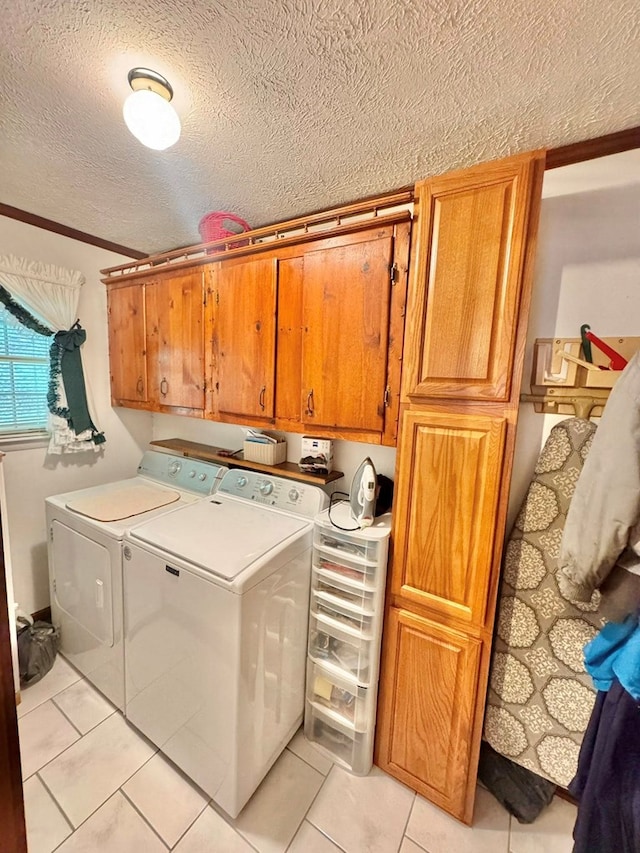 2989 Greenbrier Rd, Haysi, VA 24256 - laundry area with cabinet space, a textured ceiling, washer and clothes dryer, light tile patterned floors, and crown molding