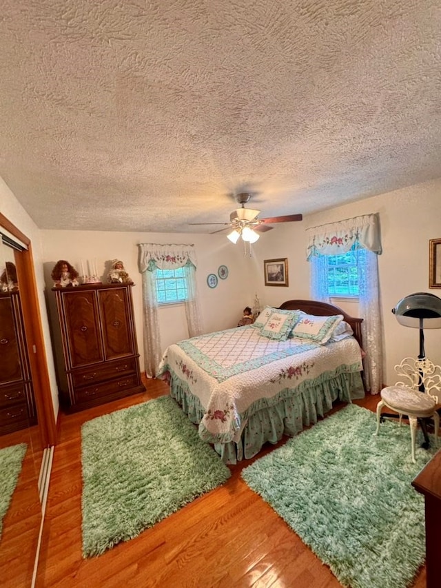 2989 Greenbrier Rd, Haysi, VA 24256 - bedroom featuring wood finished floors, a textured ceiling, and ceiling fan