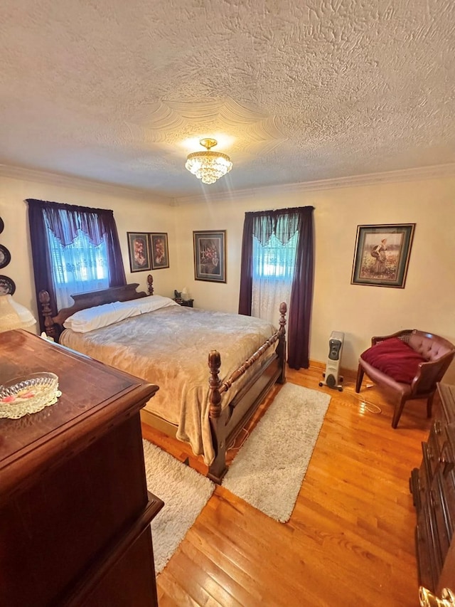 2989 Greenbrier Rd, Haysi, VA 24256 - bedroom with multiple windows, light wood finished floors, a textured ceiling, and ornamental molding