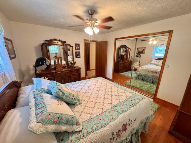 2989 Greenbrier Rd, Haysi, VA 24256 - bedroom featuring wood finished floors, a textured ceiling, a closet, and a ceiling fan
