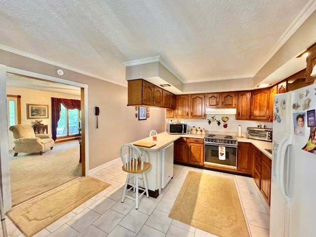 2989 Greenbrier Rd, Haysi, VA 24256 - kitchen featuring white fridge with ice dispenser, electric range oven, stainless steel microwave, brown cabinetry, and under cabinet range hood