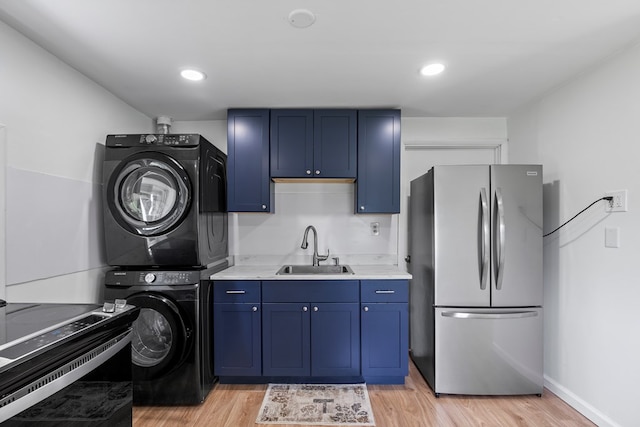 21468 Mandalay Ln, Abingdon, VA 24211 - laundry room with stacked washer and clothes dryer and light wood-style floors