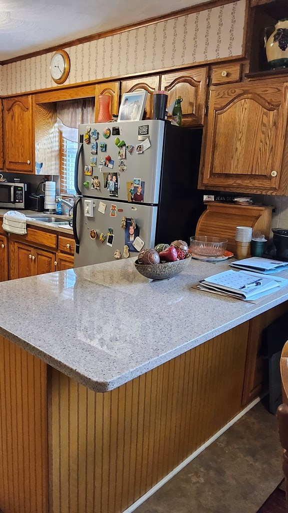 1359 Scratch Gravel Rd, Marion, VA 24354 - kitchen with stainless steel appliances, brown cabinets, and light stone countertops