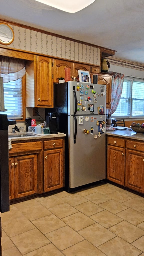 1359 Scratch Gravel Rd, Marion, VA 24354 - kitchen featuring freestanding refrigerator, brown cabinets, light countertops, and light tile patterned floors