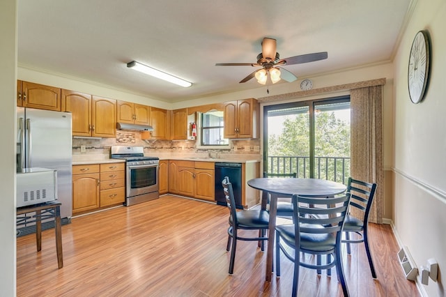 151 Woodcrest Ln, Bristol, VA 24201 - kitchen with stainless steel appliances, under cabinet range hood, light countertops, light wood-style floors, and crown molding