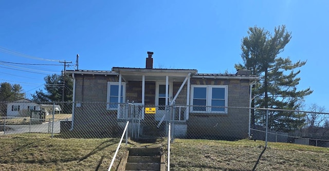 view of front facade featuring fence and a chimney