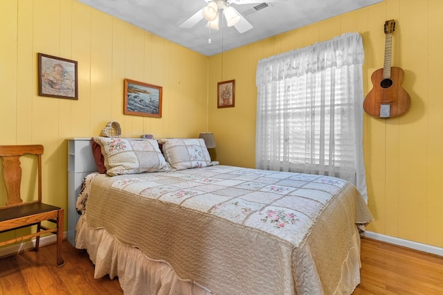 bedroom with wood-type flooring and ceiling fan