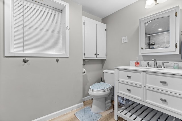 bathroom with vanity, wood-type flooring, and toilet