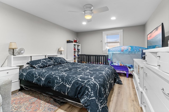 bedroom with light hardwood / wood-style flooring and ceiling fan