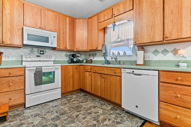 kitchen with white appliances, sink, and backsplash