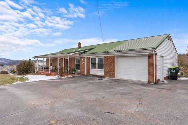 single story home with a garage and a porch