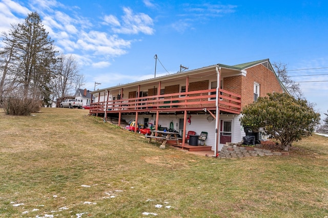 rear view of house with a yard and a deck