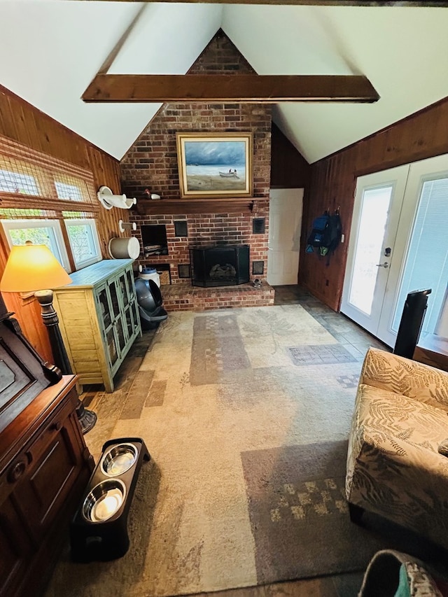 18335 Westwood Dr, Abingdon, VA 24211 - living area featuring lofted ceiling, wooden walls, healthy amount of natural light, light carpet, and a brick fireplace