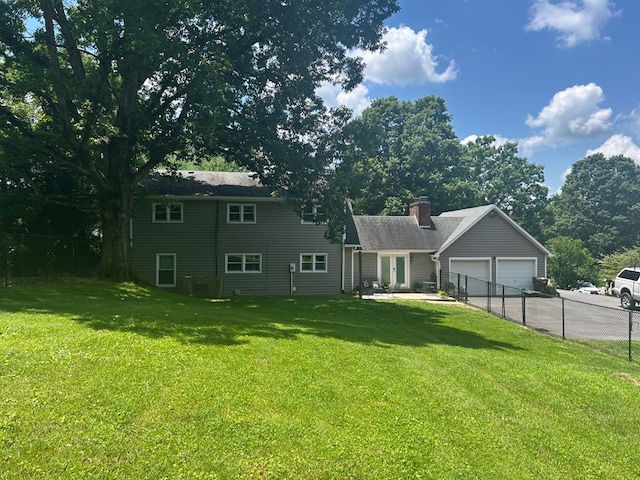 18335 Westwood Dr, Abingdon, VA 24211 - back of property with asphalt driveway, an attached garage, french doors, and a chimney
