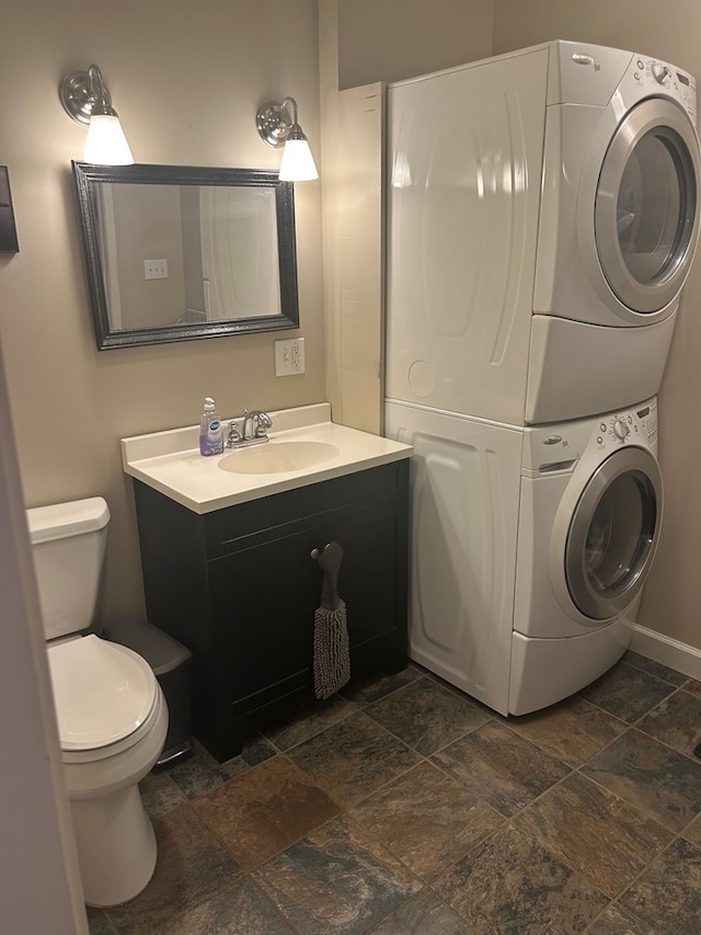 18335 Westwood Dr, Abingdon, VA 24211 - bathroom with stacked washer / drying machine, stone tile flooring, and vanity