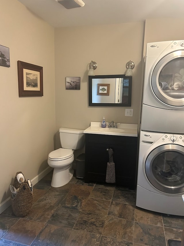 18335 Westwood Dr, Abingdon, VA 24211 - laundry area featuring stacked washer / dryer and stone tile floors