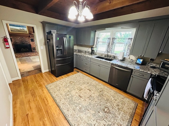 18335 Westwood Dr, Abingdon, VA 24211 - kitchen featuring stainless steel fridge, dishwasher, gray cabinets, a chandelier, and light stone countertops