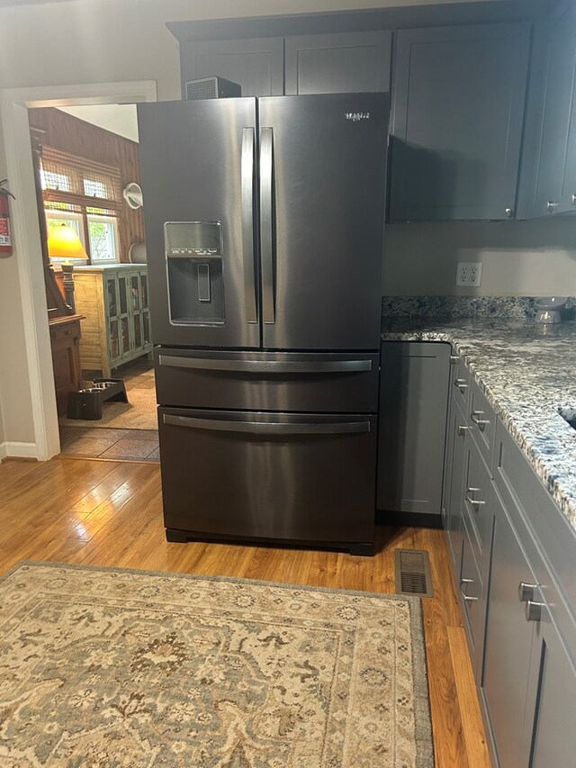 18335 Westwood Dr, Abingdon, VA 24211 - kitchen featuring stainless steel refrigerator with ice dispenser, light wood-style floors, and light stone counters