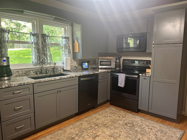 18335 Westwood Dr, Abingdon, VA 24211 - kitchen with black electric range, dishwasher, gray cabinets, and stone countertops