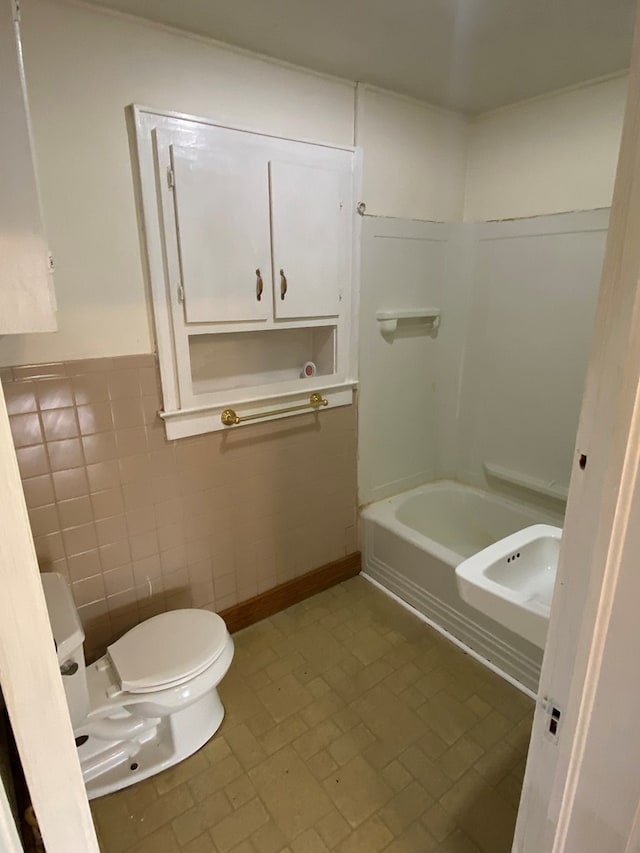 250 Staley St, Marion, VA 24354 - full bathroom featuring a bathtub, tile walls, brick patterned floors, and wainscoting