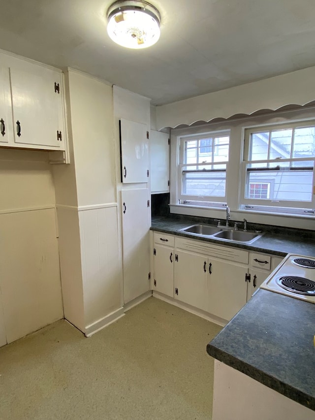 250 Staley St, Marion, VA 24354 - kitchen featuring dark countertops, a wainscoted wall, white cabinets, and white electric stove