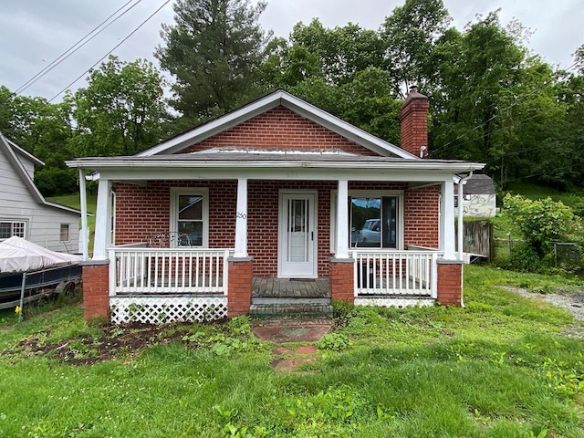 250 Staley St, Marion, VA 24354 - bungalow featuring brick siding, covered porch, and a chimney