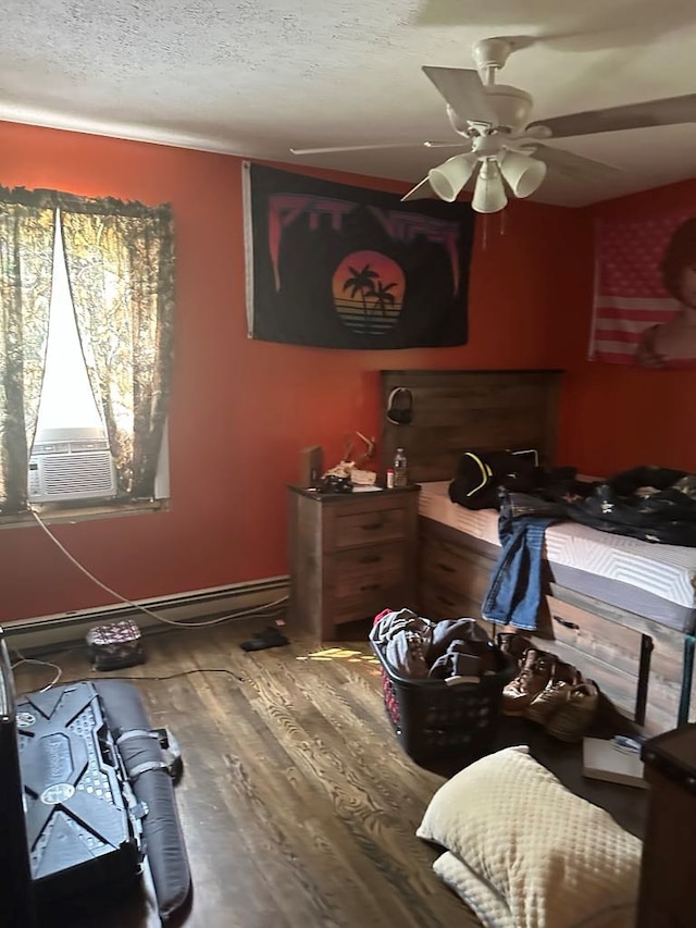 148 Rockspray Dr, Wytheville, VA 24382 - bedroom featuring wood finished floors, a ceiling fan, a baseboard radiator, and cooling unit