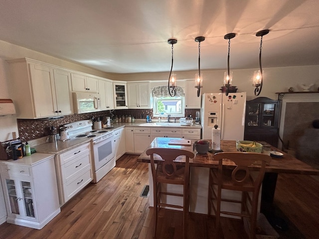 3950 Boyd Rd, Draper, VA 24324 - kitchen with white appliances, white cabinets, dark wood-style flooring, and tasteful backsplash