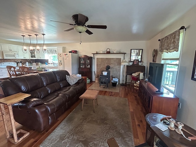 3950 Boyd Rd, Draper, VA 24324 - living room featuring wood finished floors, a wood stove, and a ceiling fan