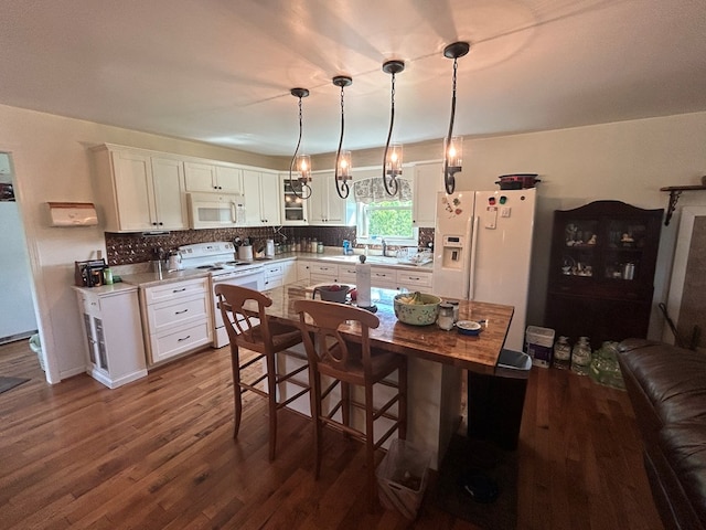 3950 Boyd Rd, Draper, VA 24324 - kitchen with white appliances, white cabinets, light countertops, and dark wood-type flooring
