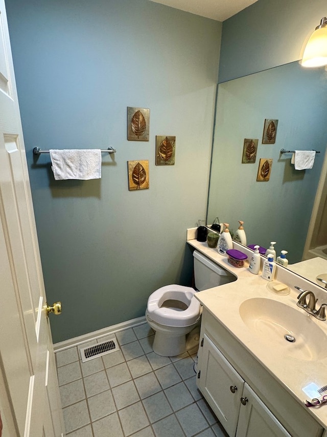 bathroom featuring vanity, toilet, tile patterned floors, baseboards, and visible vents