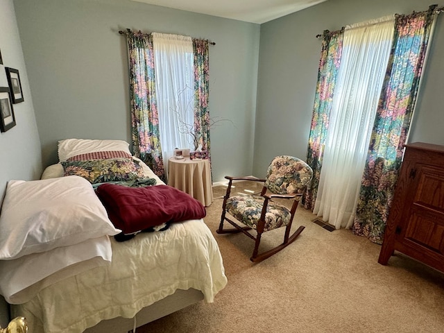 bedroom with light carpet and visible vents