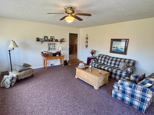 carpeted living area featuring baseboards, a textured ceiling, and ceiling fan