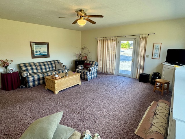 living area with carpet floors, a ceiling fan, and a textured ceiling
