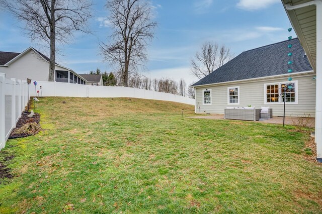 view of yard featuring a patio area, a fenced backyard, and an outdoor hangout area