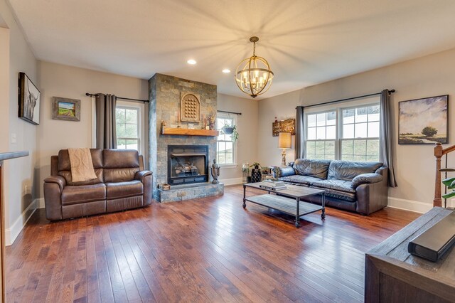 living room with baseboards, wood-type flooring, plenty of natural light, and a fireplace